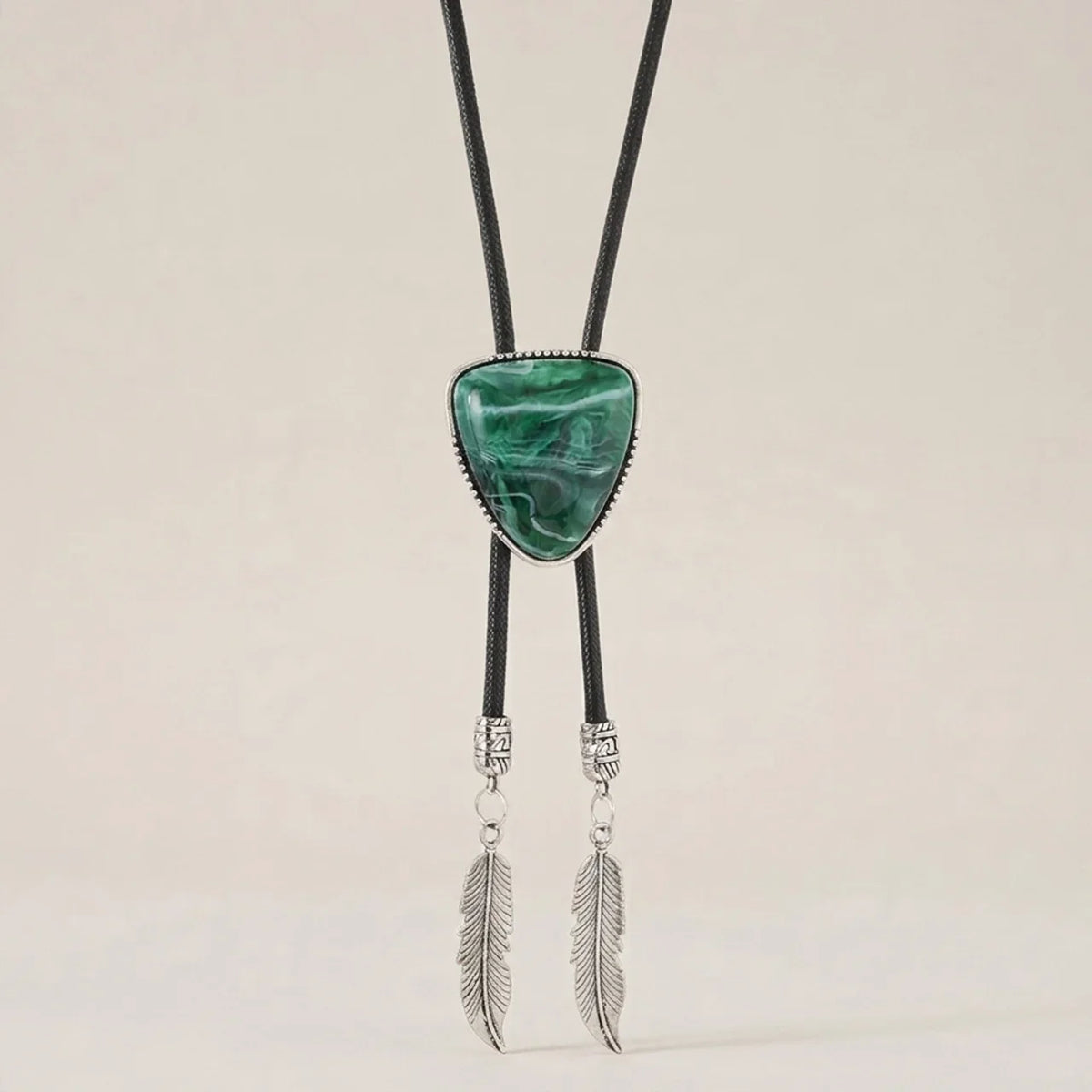 Green alloy triangle pendant necklace shown at three-quarter angle with vintage retro style