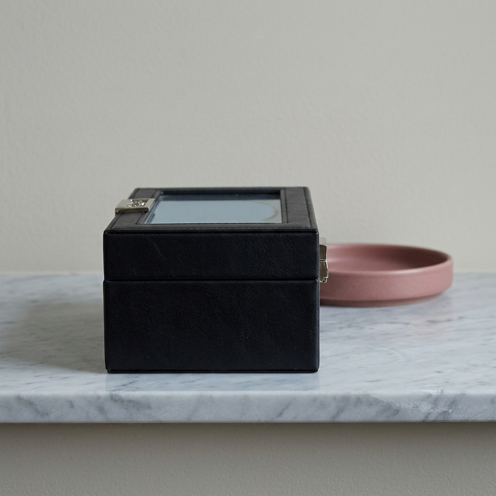 Black PU leather six-position single-layer watch storage box displayed on a dresser top in ambient room lighting