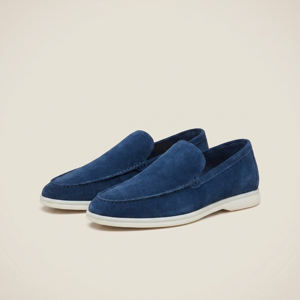 Close-up front detail of charcoal suede loafer shoe highlighting suede texture, stitching, and round toe
