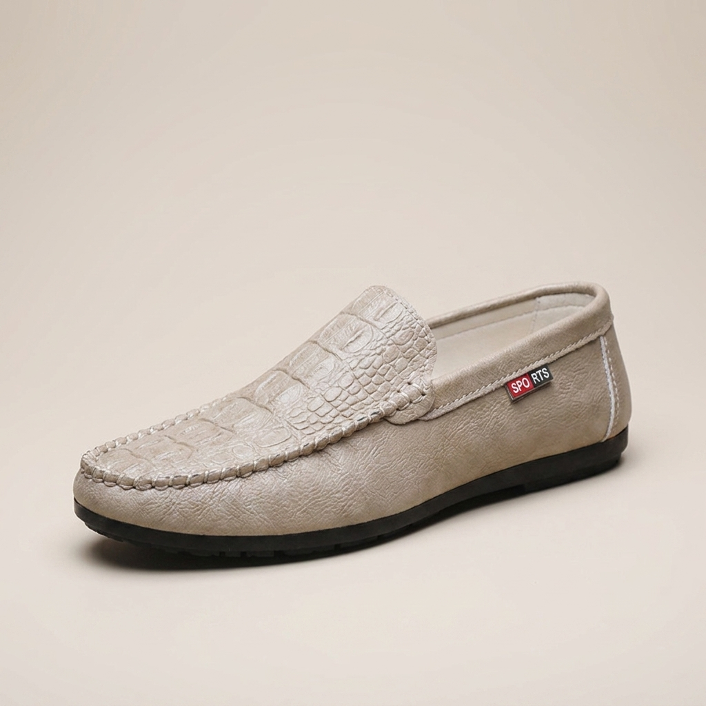 Beige synthetic leather crocodile-grain slip-on loafer shown front view with round toe and stitch detailing