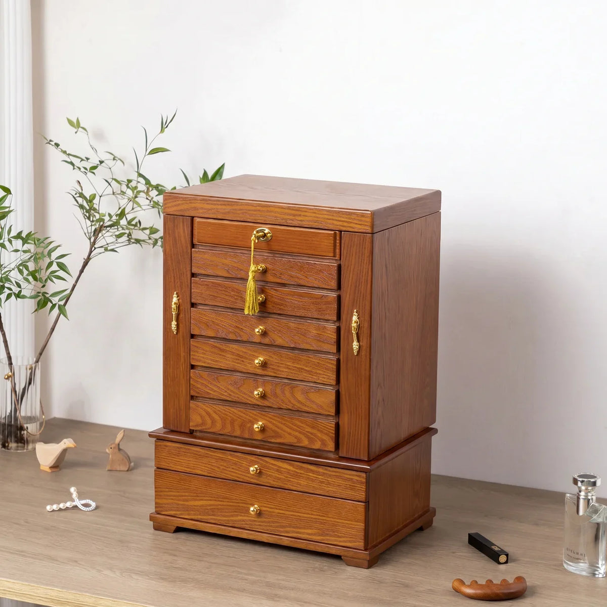 Close-up of vintage solid wood 10-layer carved jewelry box showing brass-tone hardware, velvet lining, and wood grain texture