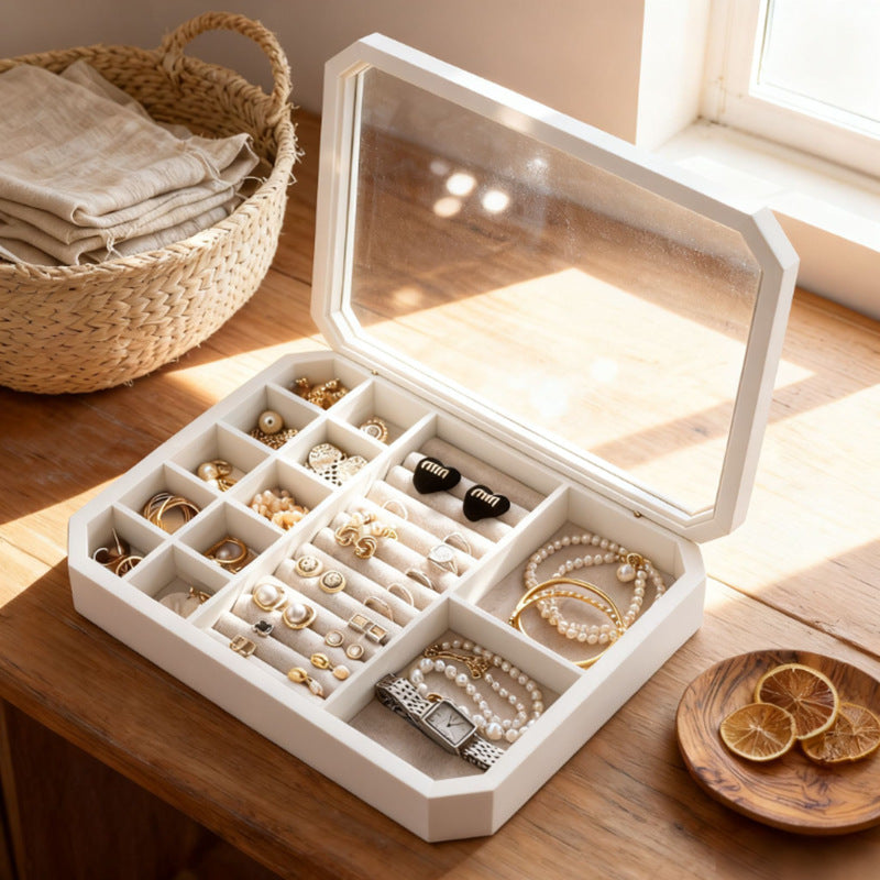 Front view of white octagonal jewelry box with glass lid in ambient room lighting
